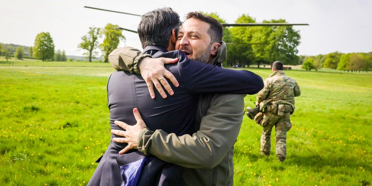 Ukrainian President Volodymyr Zelenskyy hugs British Prime Minister Rishi Sunak as he lands near London on May 15, 2023.