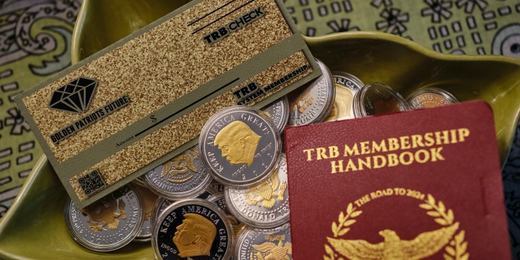 A booklet, check and collection of coins bought by Alabama grandmother when she invested in “Trump Buck,” in her apartment in Mobile, Ala., on May 19, 2023.  