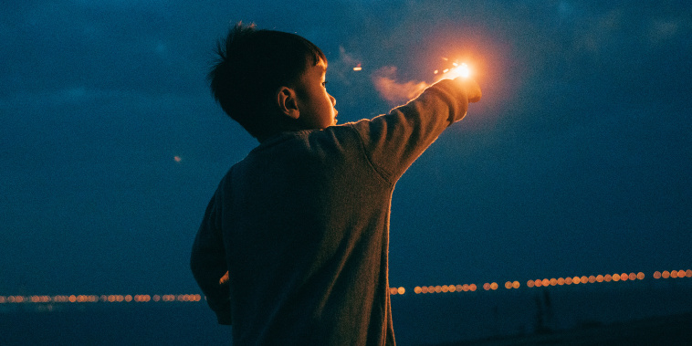 a boy playing with Fireworks