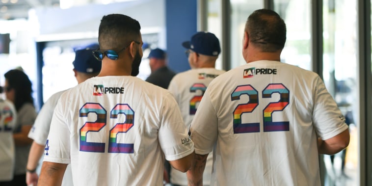 Attendees wearing special LGBTQ+ Pride Night commemorative shirts at Dodger Stadium in Los Angeles