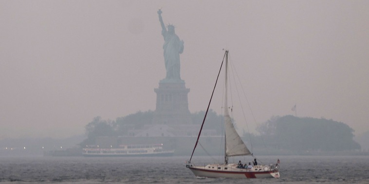 The Statue of Liberty stands shrouded in a reddish haze as a result of Canadian wildfires on June 06, 2023 in New York City. Over 100 wildfires are burning in the Canadian province of Nova Scotia and Quebec resulting in air quality health alerts for the Adirondacks, Eastern Lake Ontario, Central New York and Western New York.