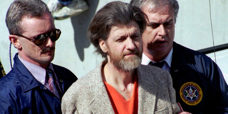 Theodore "Ted" Kaczynski is is escorted from the federal courthouse in Helena, Mont