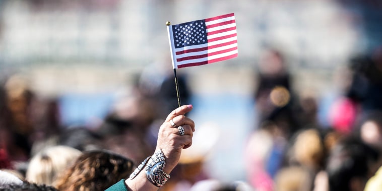 Image: People recite an oath during a naturalization ceremony on Feb. 15, 2023, in San Diego.