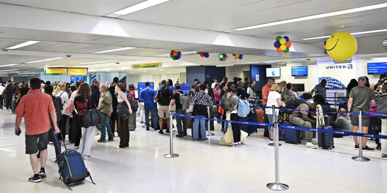 Passengers wait at Newark Liberty International Airport in Newark, N.J.