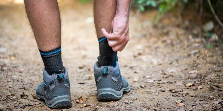 Close up of the itchy legs of a hiker walking through the woods.