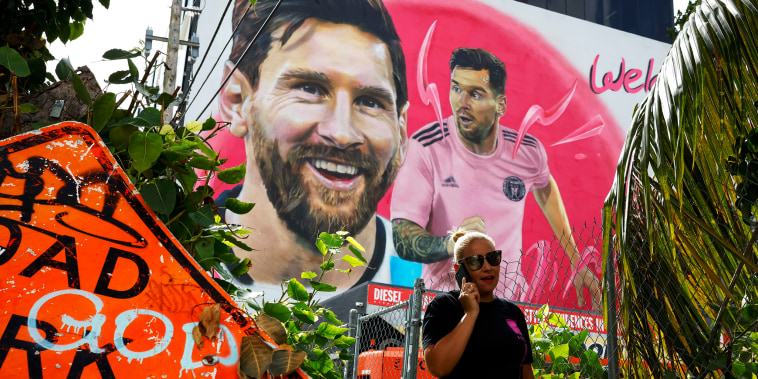 A person walks pass a giant mural of international soccer star Lionel Messi made by Maximiliano Bagnasco, an Argentine artist, on July 20, 2023 in Wynwood, Miami’s art district, Florida.