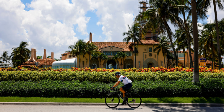 A cyclist rides past the Mar-a-Lago Club in Palm Beach, Fla., on June 11, 2023.