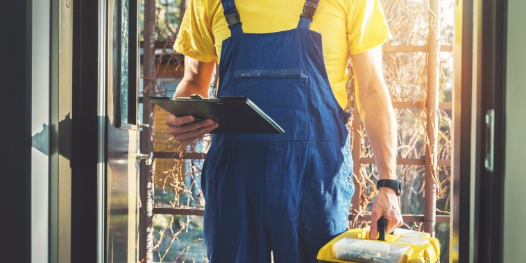 handyman services - repairman with toolbox standing at home entrance