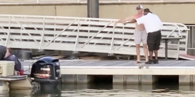 Two men discuss the location of a boat at the Montgomery Riverfront, Alabama, on Aug. 5, 2023.