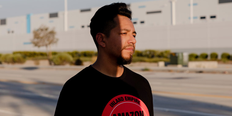 Daniel Rivera poses for a portrait in front of the Amazon warehouse where he works in Highland, Calif.