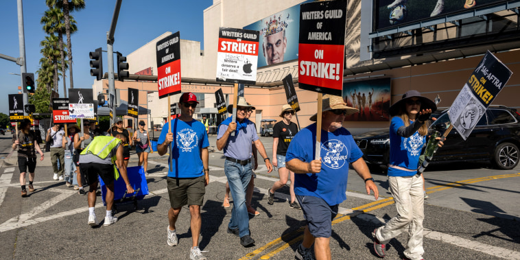 Members and supporters of SAG-AFTRA and WGA walk the picket line at Fox Studios