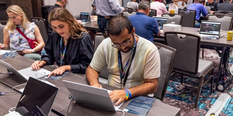 Volunteers attempt to trick chatbots into saying terrible things at AI Village during Def Con in Las Vegas on Aug. 10, 2023.