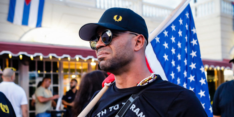 Henry "Enrique" Tarrio holds a flag while protesting in Miami
