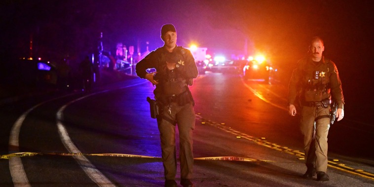 Police officers work at the scene of a shooting "Cook's Corner"