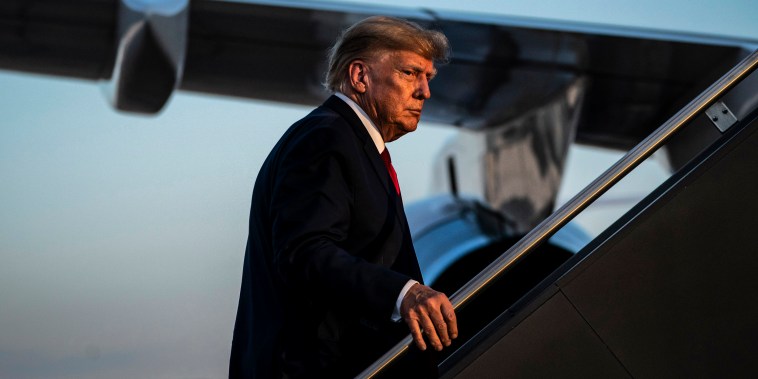 Former President Donald Trump boards his airplane in Manchester, N.H., on April 27, 2023.