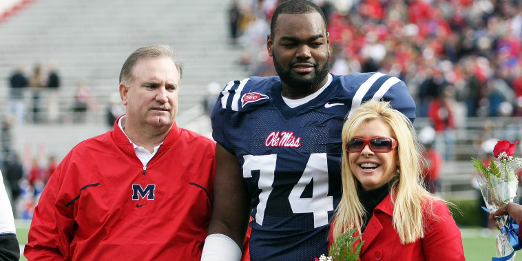 Michael Oher #74 of the Ole Miss Rebels stands with his family 