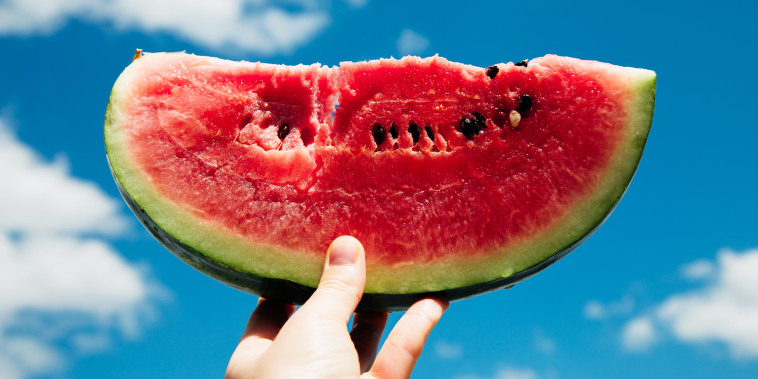 Slice of watermelon in hand