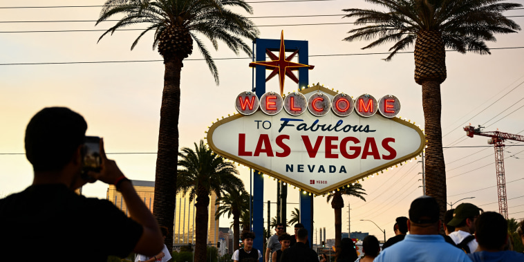 People take pictures with the "Welcome To Fabulous Las Vegas" sign on July 29, 2023.
