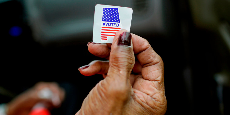 Sadie Janes shows off her voting sticker after casting her ballot during the Democratic presidential primary in Montgomery, Ala., on March 3, 2020.