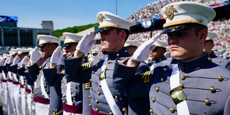 U.S. Military Academy graduating cadets salute at a commencement ceremony