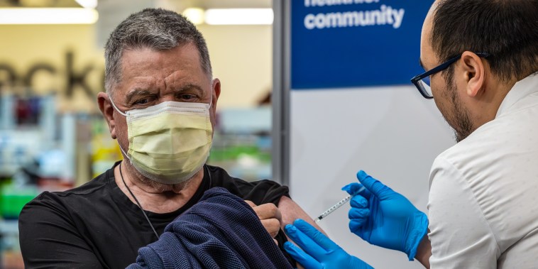 A pharmacist administers a new mRNA Covid vaccine COMIRNATY by Pfizer at CVS Pharmacy in Eagle Rock, Calif., on Sept. 14, 2023.