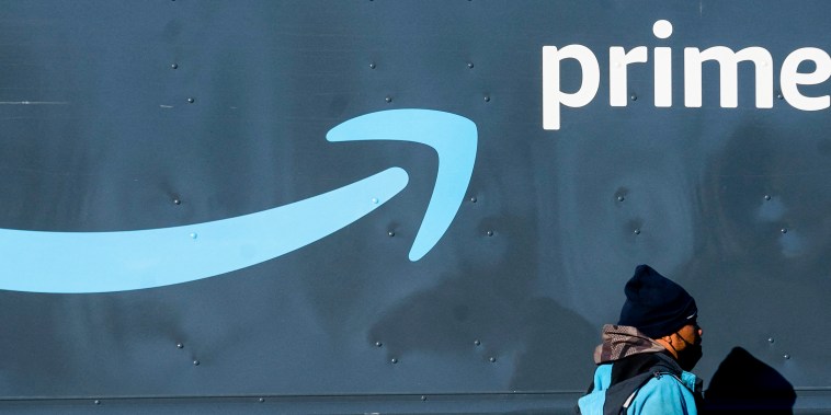 An Amazon worker walks past his truck in Washington, D.C., on Feb. 19, 2022.