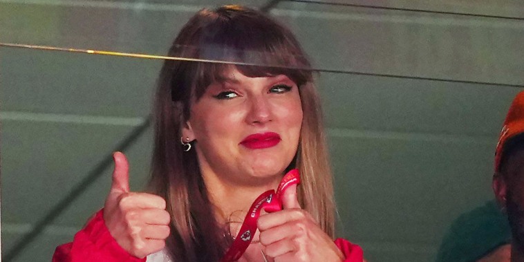 Taylor Swift reacts during a football game