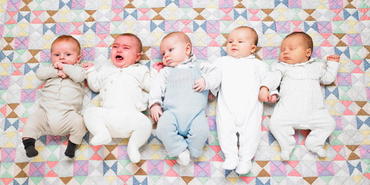 Five babies on quilt