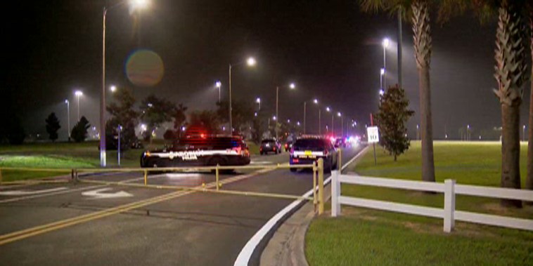 Police respond following a shooting that broke out at a football practice in Apopka, Florida.