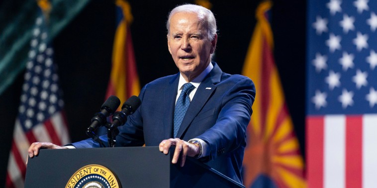 President Joe Biden speaks speaks onstage at a podium