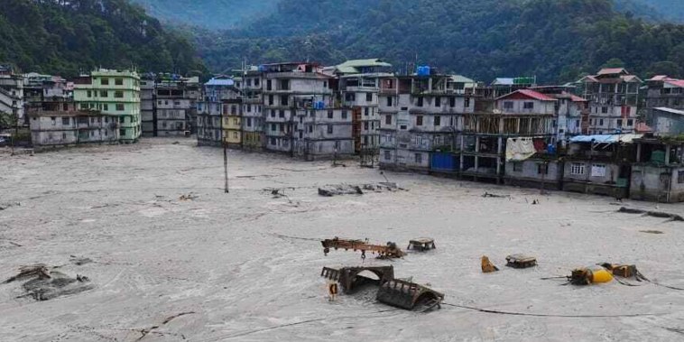 A flood that burst through a major hydroelectric dam in India's Himalayan northeast killed at least 31 people, officials said Friday, as ice-cold water swept through mountain towns, washing away houses and bridges and forcing thousands of people to leave their homes. 