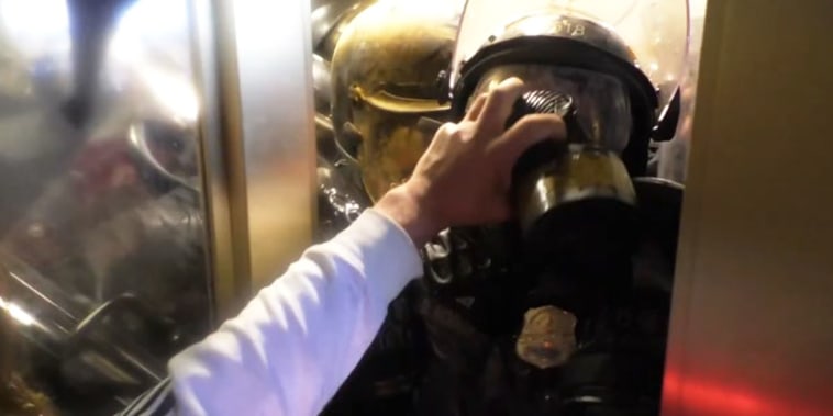 Steven Cappuccio grabs Officer Daniel Hodges mask