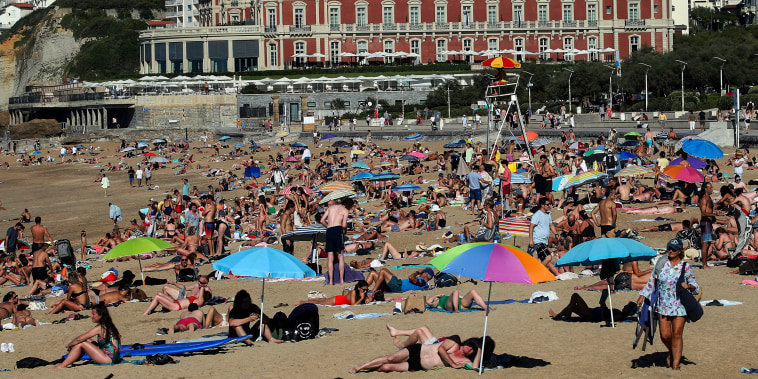 People sunbathe in France in October.