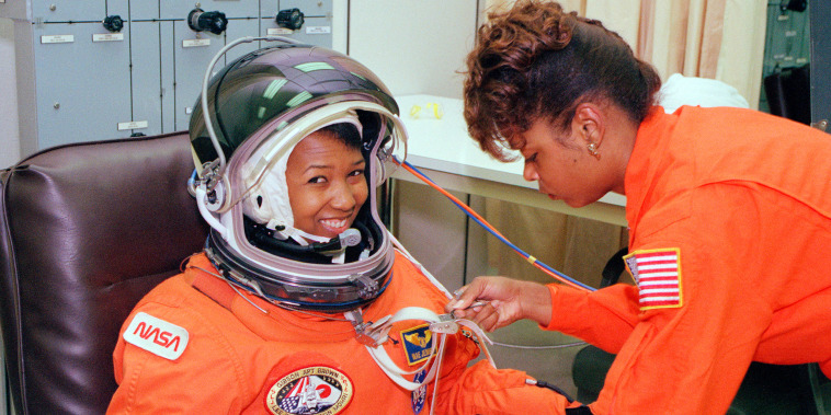 Mae Jemison smiles as a technician performs tests on her spacesuit.