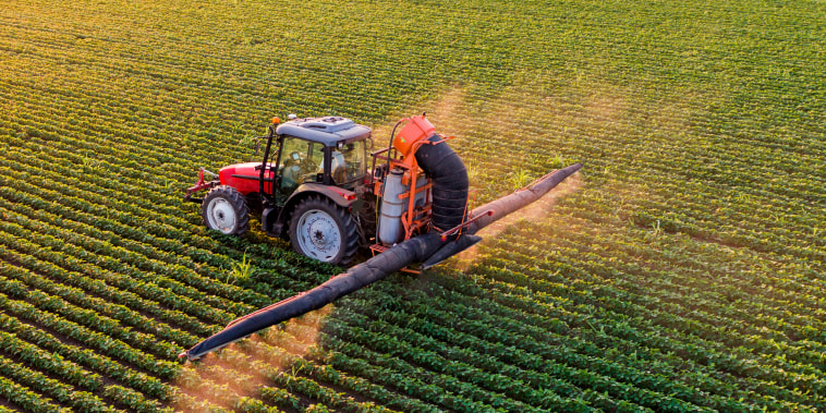 A tractor spraying crops.