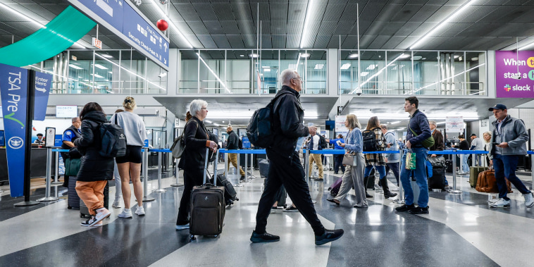 Travelers walk through O'Hare International Airport in Chicago, Illinois, on Nov. 21, 2023. 