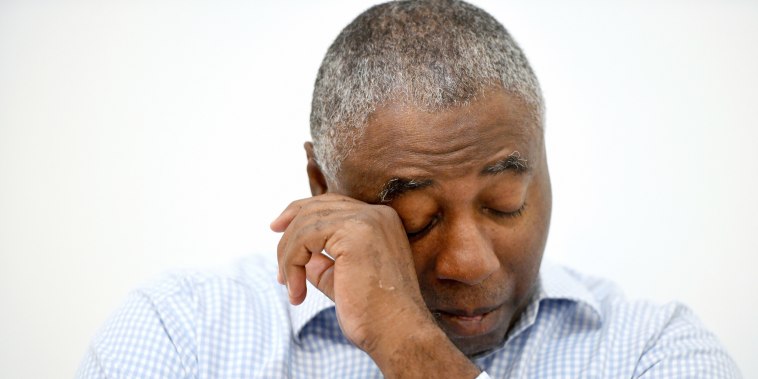 Charles Richardson wipes his eye while discussing his alleged abuse decades ago by a Catholic priest.