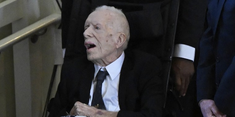 Former US President Jimmy Carter arrives for a tribute service for former US First Lady Rosalynn Carter