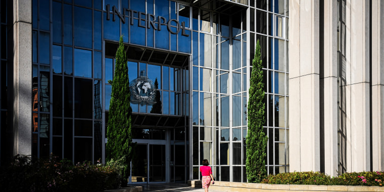 A woman walks towards the entrance of the International Criminal Police Organization headquarters, known as Interpol, in Lyon,France on Sept. 5, 2023. 