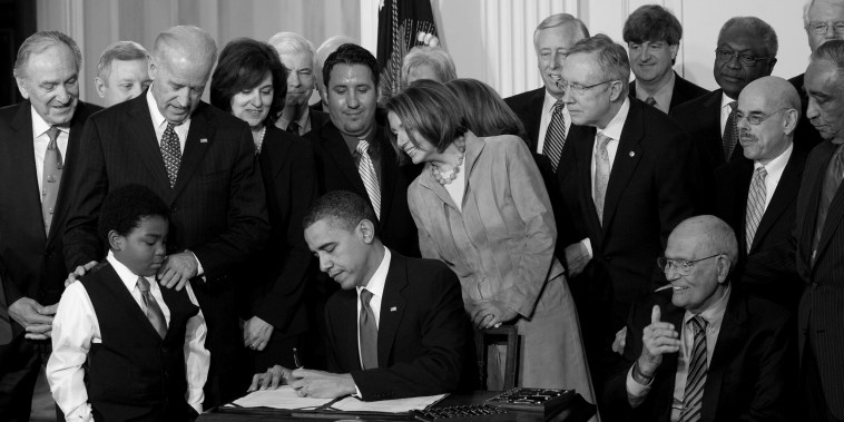 Image: Former US President Barack Obama signs the healthcare insurance reform