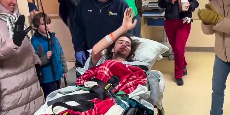 Hisham Awartani, who was paralyzed from the chest down when he was among three Palestinian college students shot over Thanksgiving weekend in Vermont, was released Wednesday from a hospital to rousing applause, according to video shared by his family.