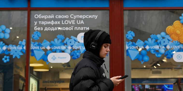 A woman walks by a Kyivstar store in Kyiv, Ukraine