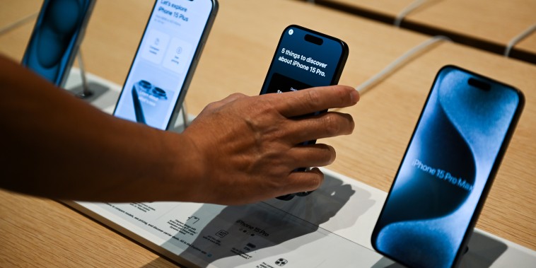 A customers looks at an iPhone 15s at the Apple store in Palo Alto, Calif