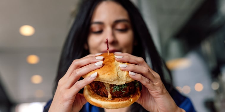 Woman eating a veggie burger
