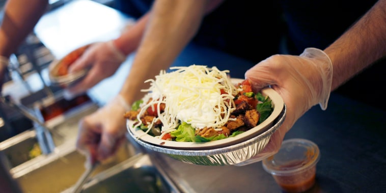 An employee prepares a burrito bowl at a Chipotle Mexican Grill.