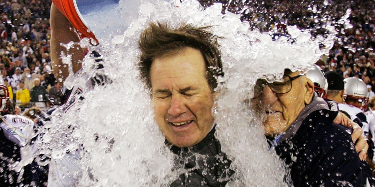 A bucket of ice is emptied on Bill Belichick.