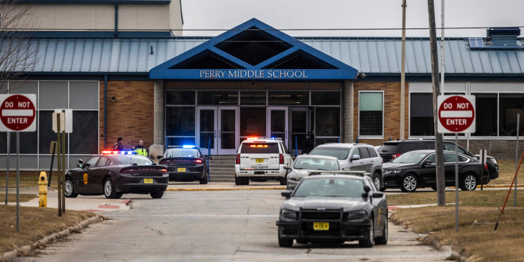 Image: Police officers secure the campus at Perry Middle and High School