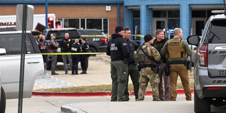 Officers stand in the parking lot of Perry High School