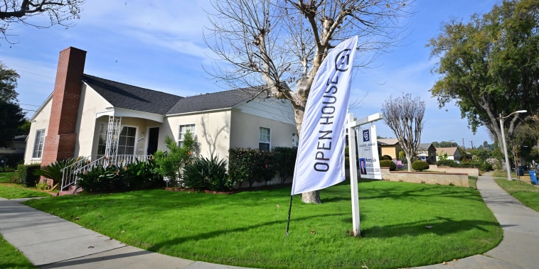An "Open House" flag is seen in front of a home for sale in Alhambra, California on January 18, 2024.