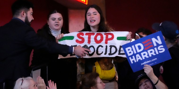 A protester interrupts President Joe Biden during an event today on the campus of George Mason University in Manassas, Va.